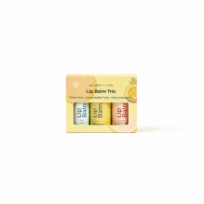 Oliver Flynn limited-edition Summer Lip Balm Trio in Summer Sunshine, Yuzu, and Piña Colada, made with beeswax, plant oils, and vitamin E.