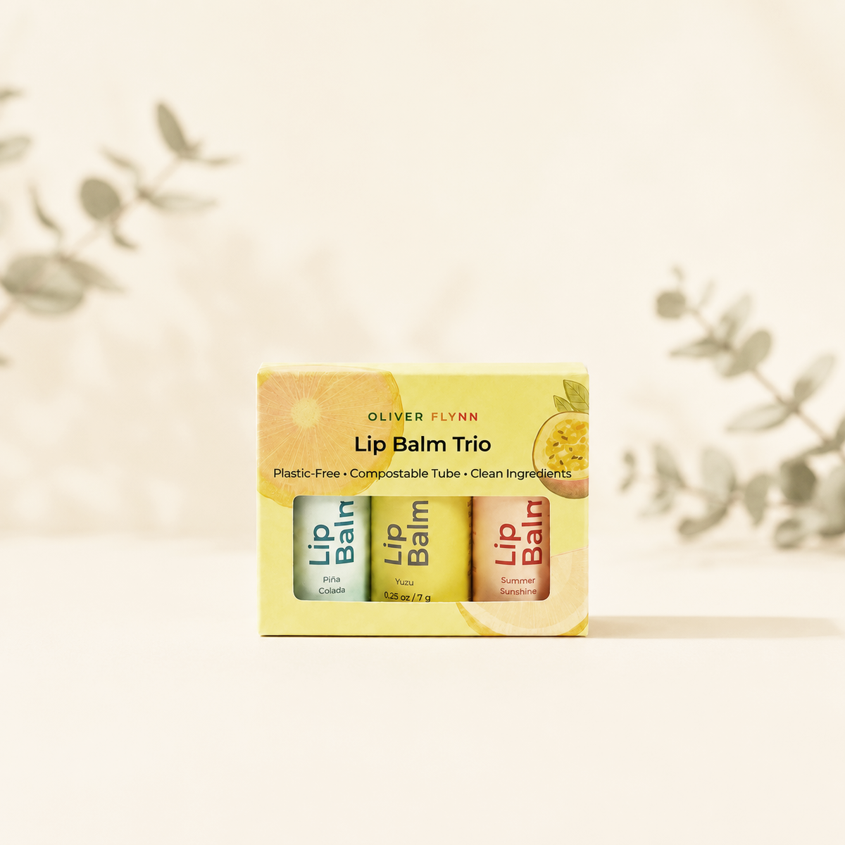 Oliver Flynn limited-edition Summer Lip Balm Trio in Summer Sunshine, Yuzu, and Piña Colada, made with beeswax, plant oils, and vitamin E.