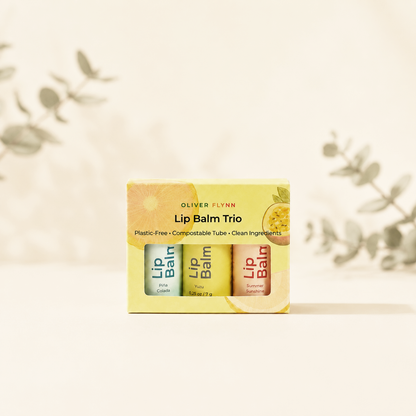 Oliver Flynn limited-edition Summer Lip Balm Trio in Summer Sunshine, Yuzu, and Piña Colada, made with beeswax, plant oils, and vitamin E.