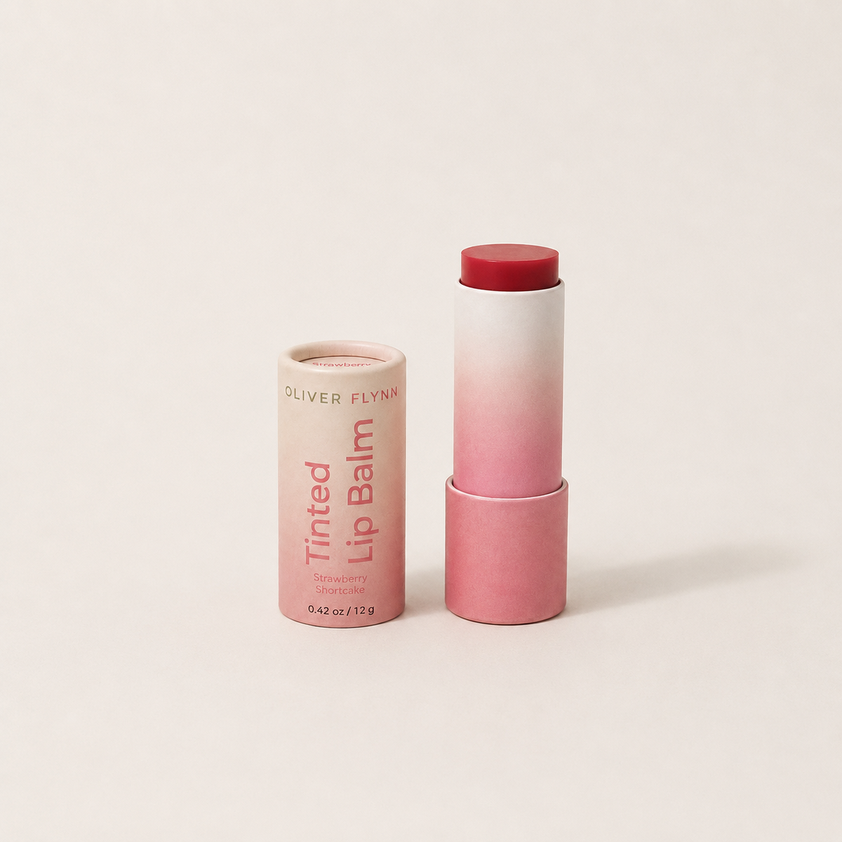 Oliver Flynn Strawberry Shortcake Tinted Lip Balm with a sheer, buildable strawberry-pink tint for moisturized lips and a natural rosy glow.