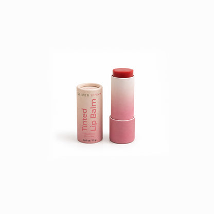 Oliver Flynn Strawberry Shortcake Tinted Lip Balm with a sheer, buildable strawberry-pink tint for moisturized lips and a natural rosy glow.